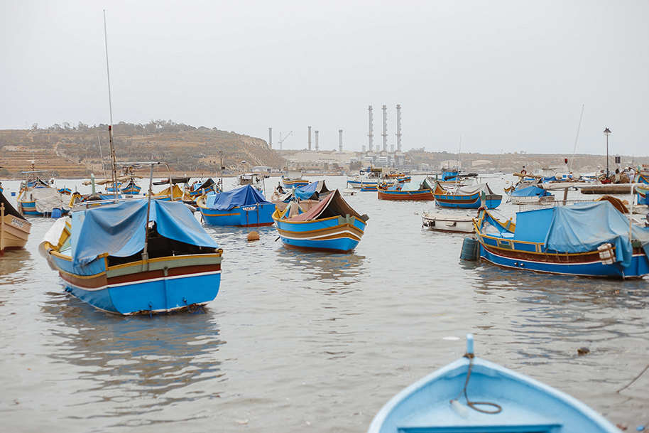 Luzzu boats in a Marsaxlokk bay, Malta